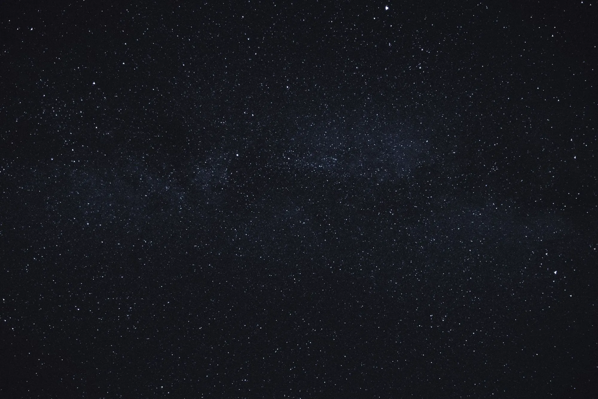 A night sky dense with stars, the faint band of the Milky Way crossing the middle.